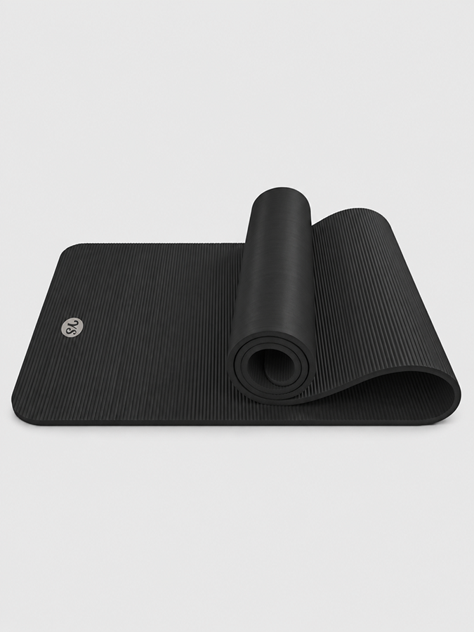 Black 10mm fitness and Pilates mat partly rolled